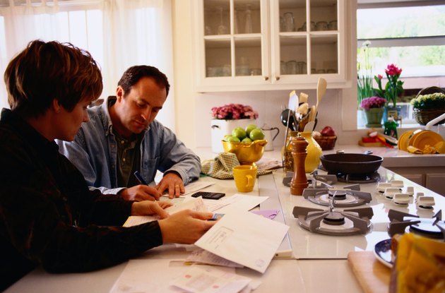 Couple Managing Their Finances in the Kitchen