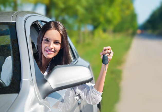 Beautiful woman holding car keys