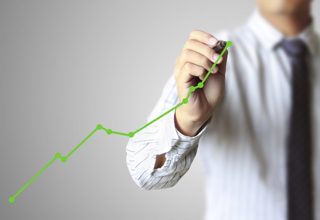 Business man hand drawing graph