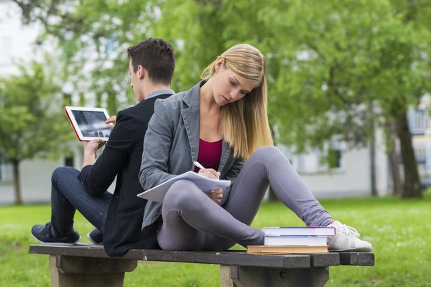 Student Couple Study On The Bench