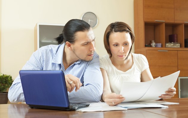 serious couple reading document