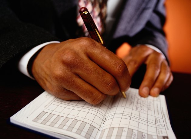 Businessman Writing in Checkbook