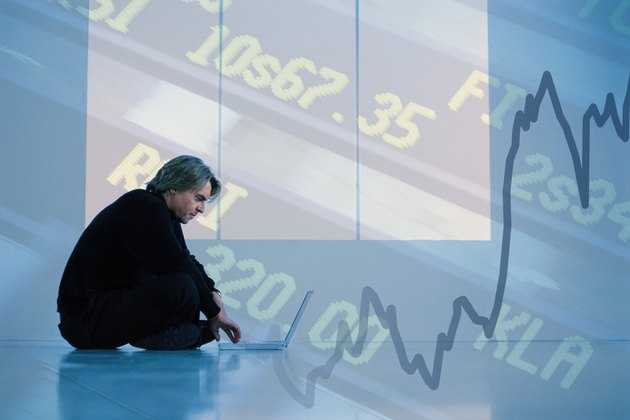 Man with a laptop and stock quotes