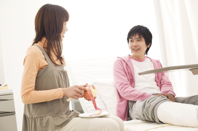 Woman peeling an apple for her boyfriend