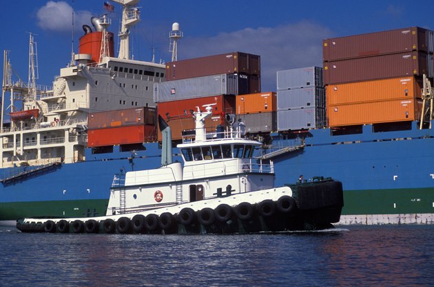 Tugboat Guiding A Giant Barge