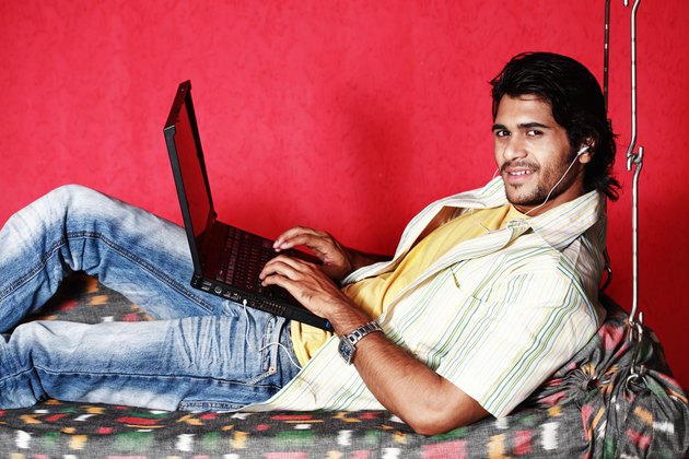 Man using laptop in a swing