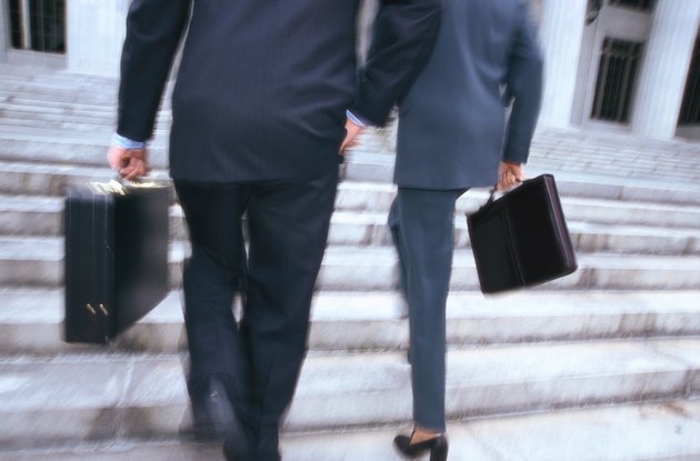 business executives with briefcases climbing stairs