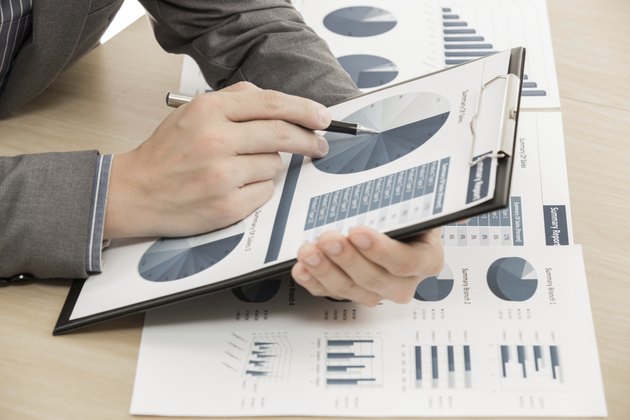 business report and man hand with pen