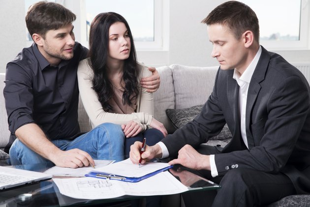 Agent advises the couple, signing documents
