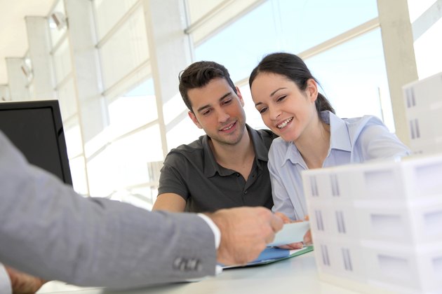 Happy young couple buying new house
