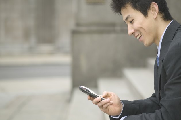 Mid adult businessman operating a mobile phone