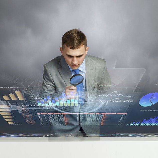 Man looking in magnifier