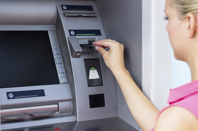 Young woman using a ATM