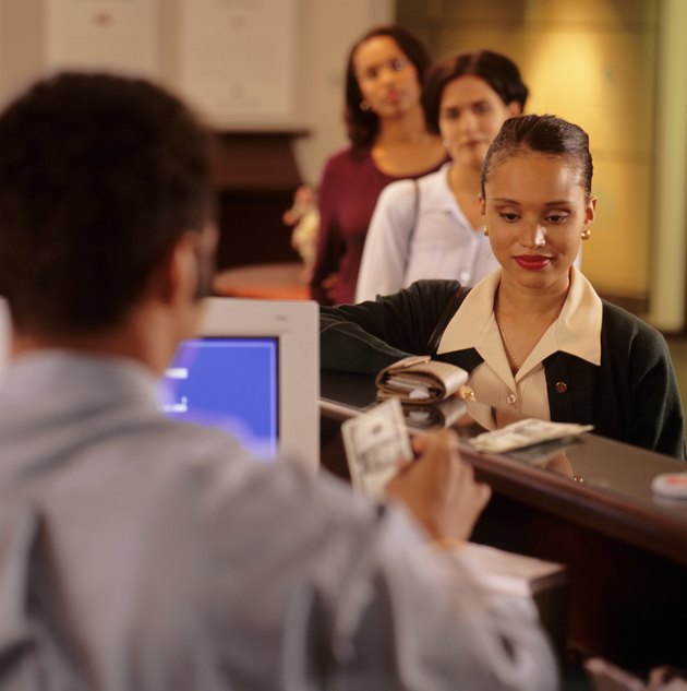 Woman withdrawing money at bank