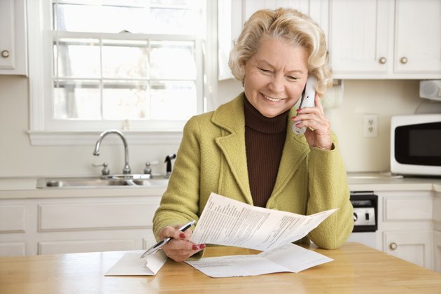 Senior woman smiling as she talks on cordless phone