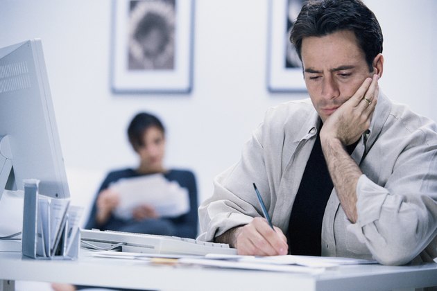 Man writing at desk