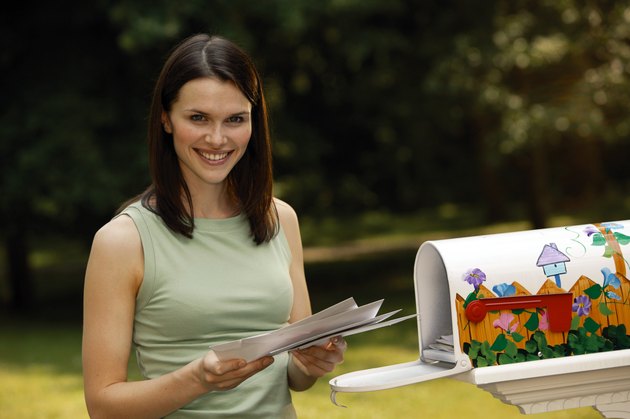 Woman getting mail from mailbox