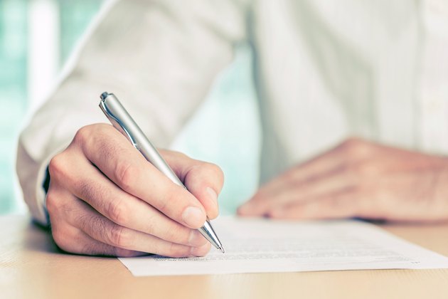 Hand signing a document