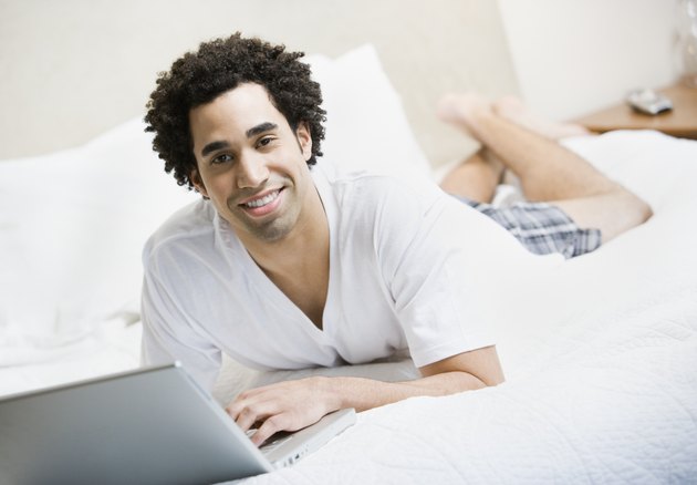 African man typing on laptop