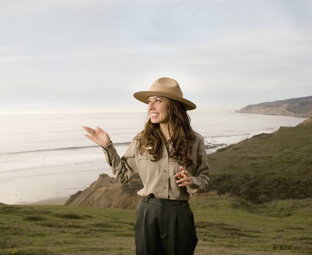 Hispanic female park ranger in front of ocean