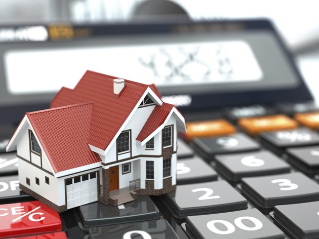 Real estate concept. House on calculator. Mortgage.
