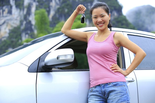 happy woman driver with her first car