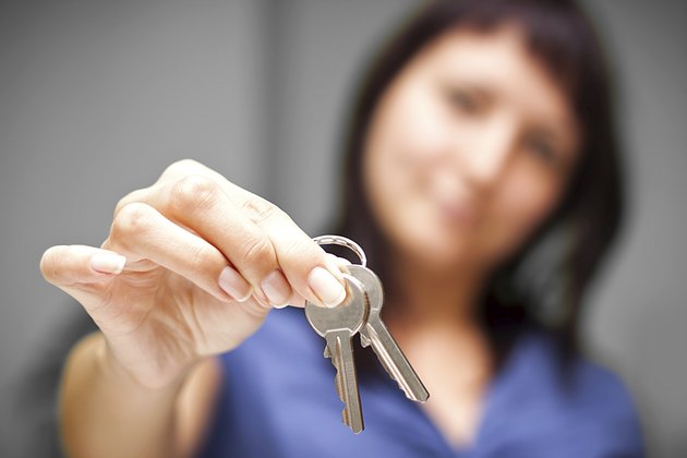 Realtor in empty apartment giving keys