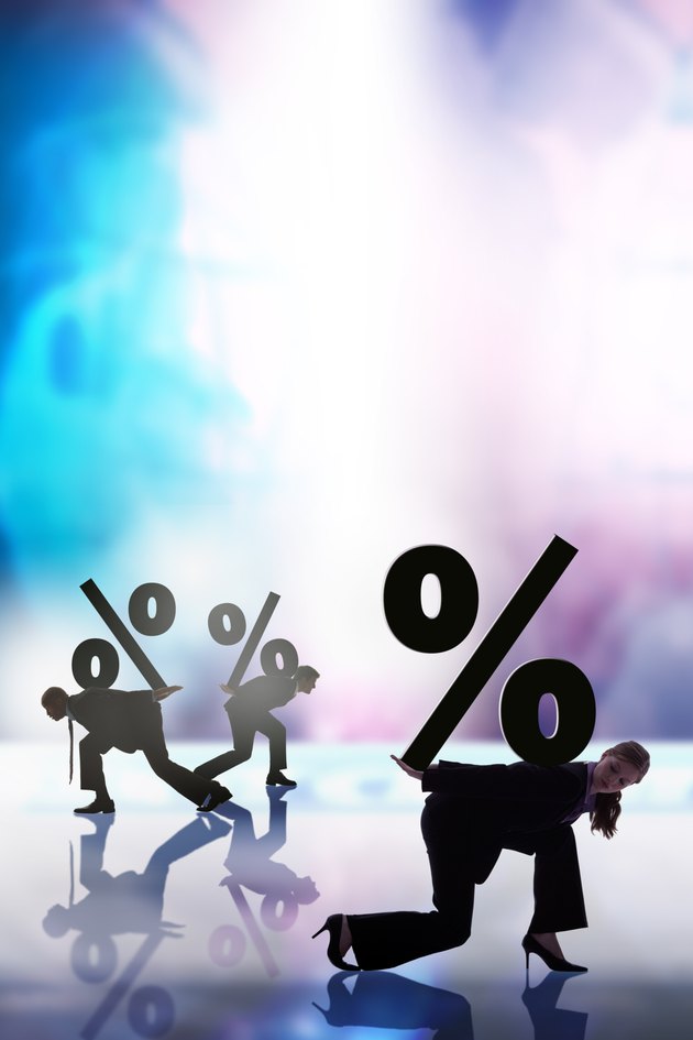 Businesspeople carrying financial symbols