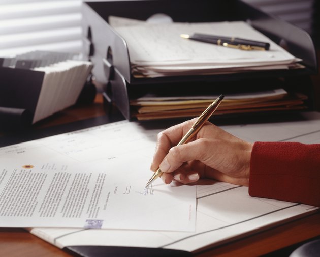 Businesswoman signing document in office