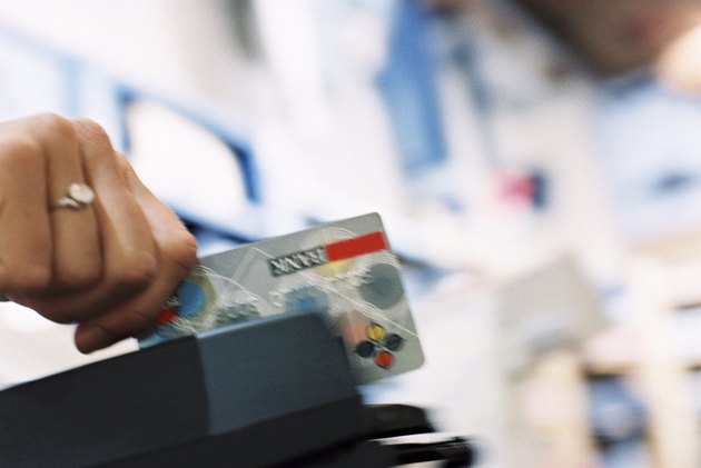 Hand swiping credit card