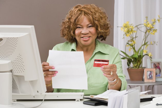 Woman at computer with credit card