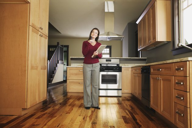 Woman inspecting empty kitchen