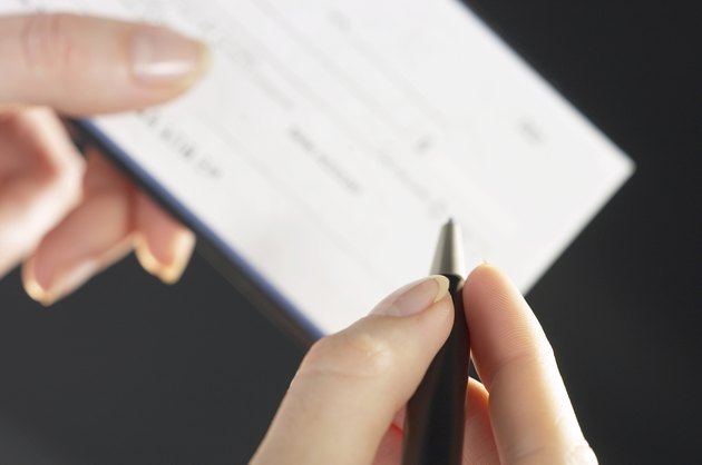 Woman writing a check