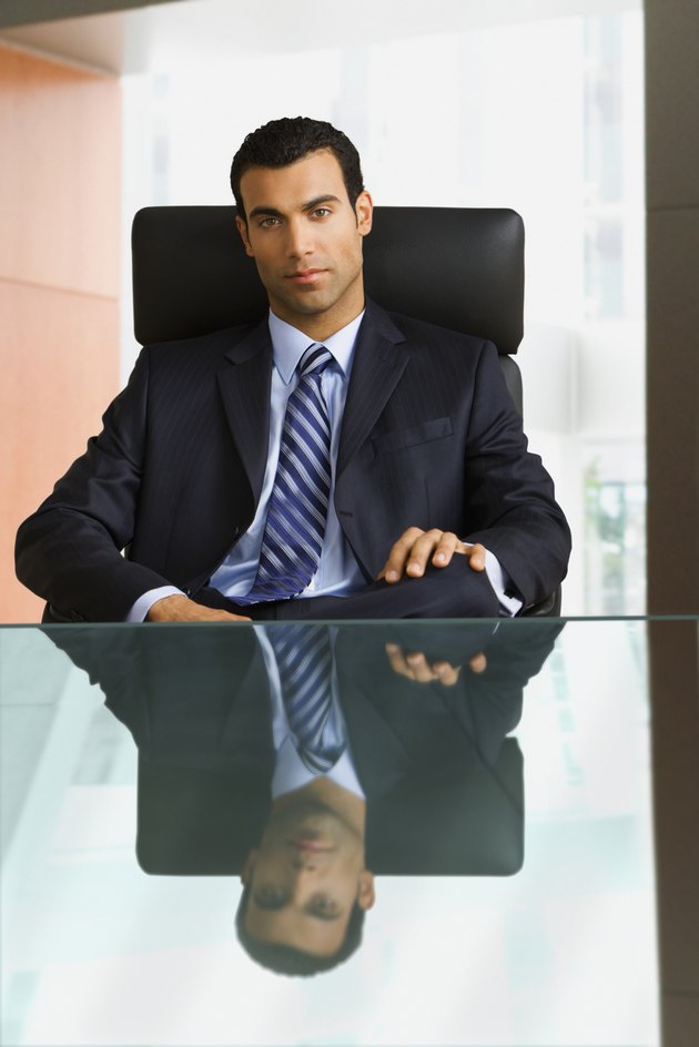 Hispanic businessman sitting at desk