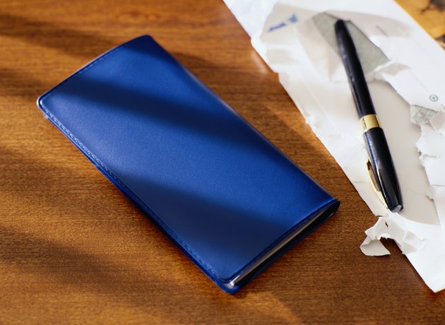 Checkbook Next to Opened Envelope