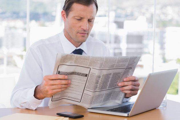 Businessman reading a newspaper
