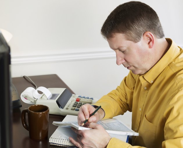 Mature man taking data off the computer