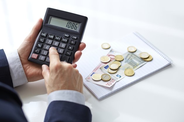 Men's hands with calculator