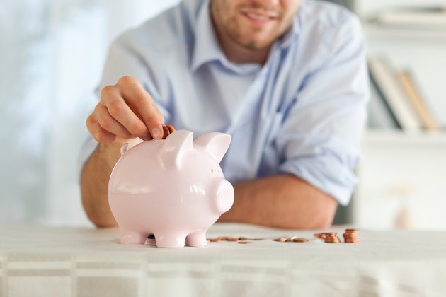 Change being put into piggy bank