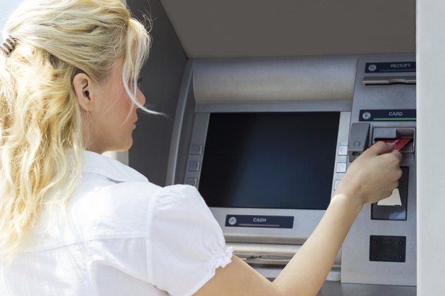 Businesswoman withdrawing money
