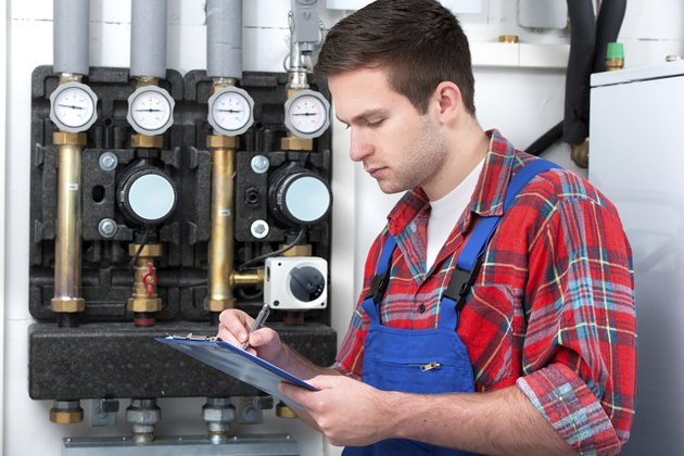 Technician servicing heating boiler