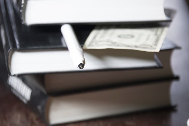 pile of books and money