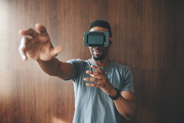 Black man using virtual reality goggles
