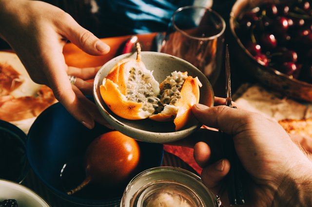 Passing a bowl of fruit at table, picnic table