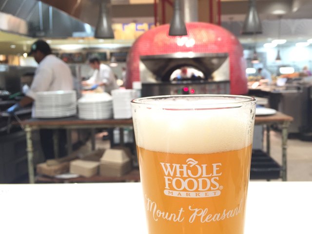 Beer in front of wood-firing oven at Whole Foods