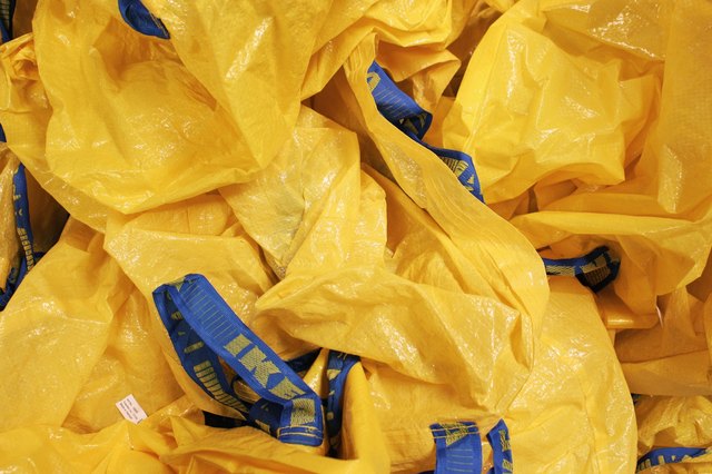 Pile of yellow IKEA reusable plastic shopping bags