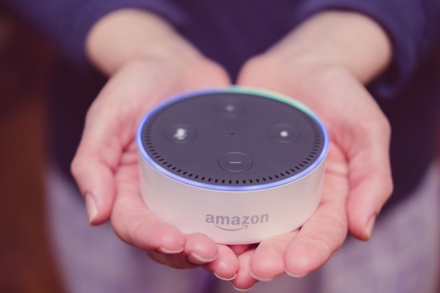 Woman holding Amazon Echo Dot in cupped palms