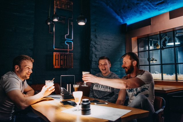 Three men at a hip bar/restaurant