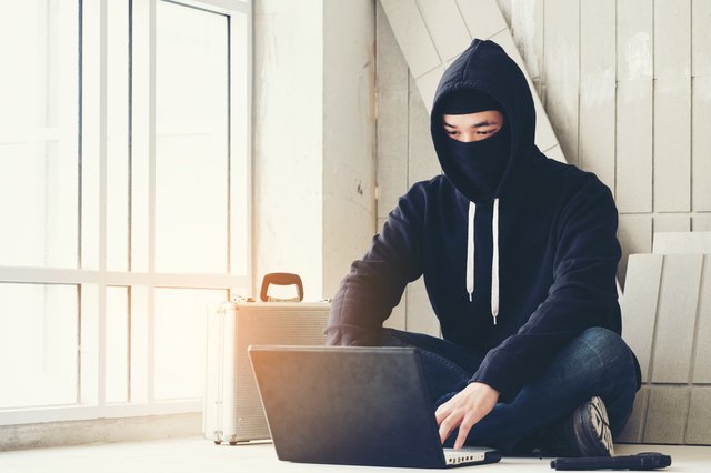 "Ninja" sitting on floor at laptop