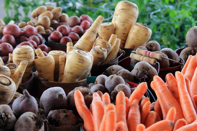 Buckets of root vegetables in produce aisle